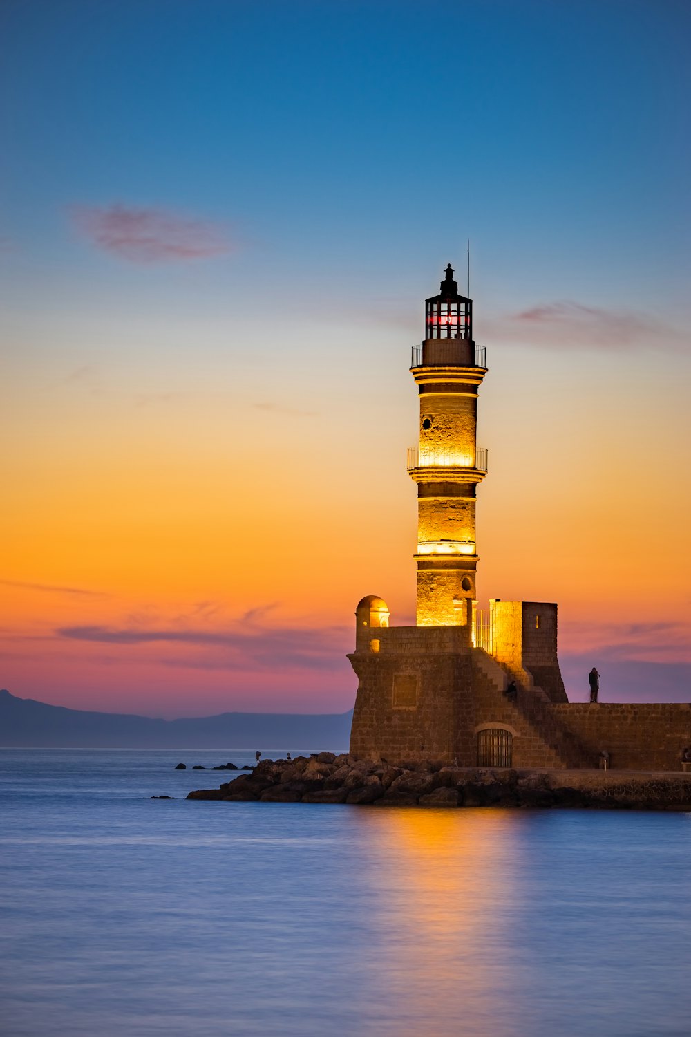 The Venetian lighthouse at the old harbour of Chania, Crete, at sunset